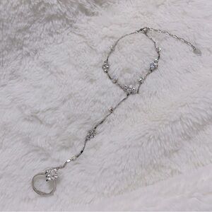 Hand jewelry piece (ring with attached bracelet) + extra ring